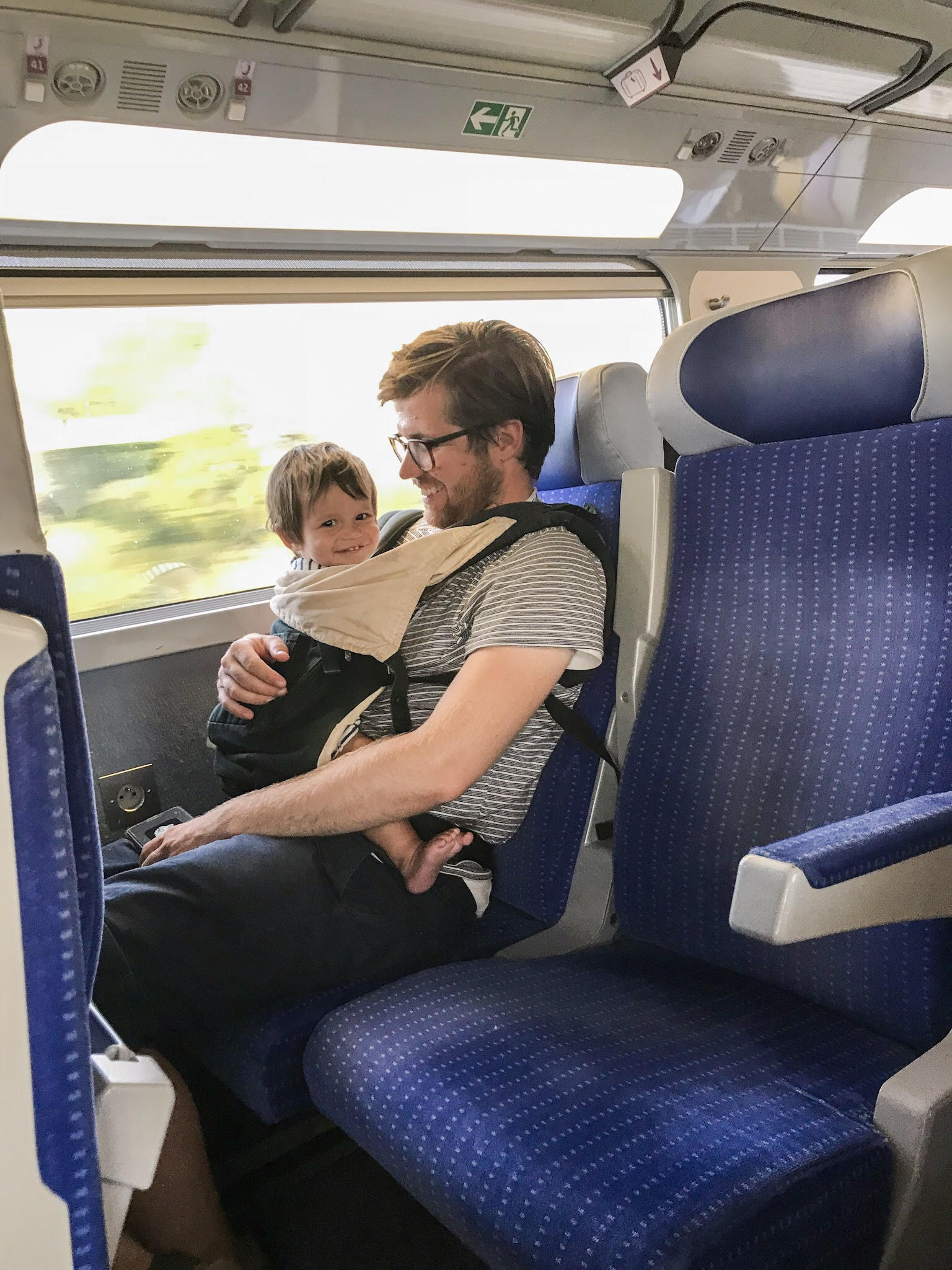 baby in carrier on train