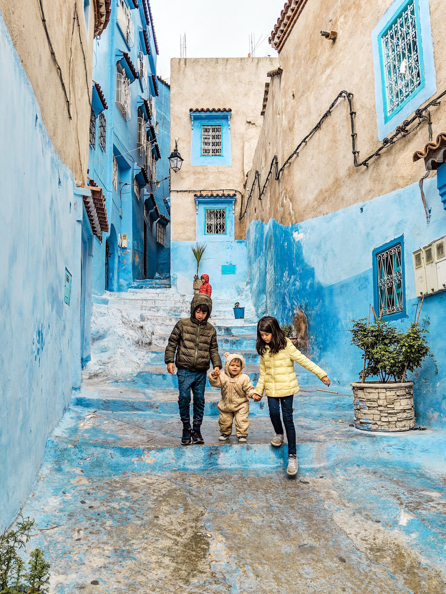kids walking chefchaouen blue city steps