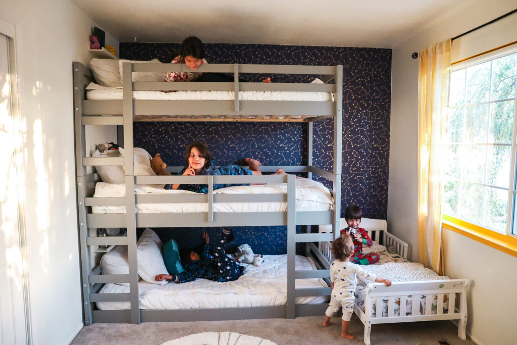 four kids sleeping in a room